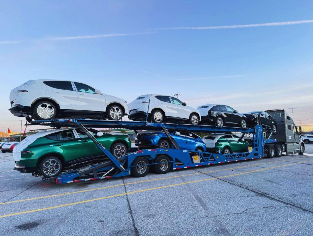 Blue carrier loaded with new SUVs